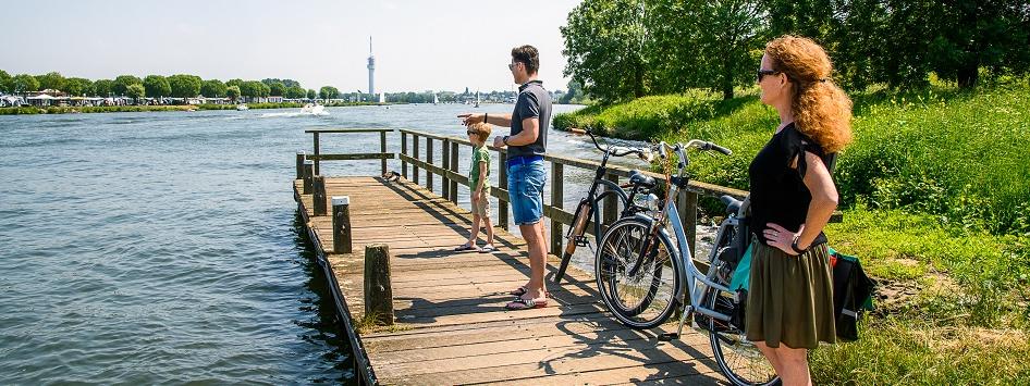 Woman, man and child wait for the bicycle ferry Biej Ool Euver