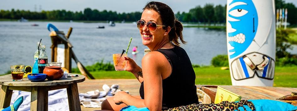 Woman enjoys a drink in her summervacation