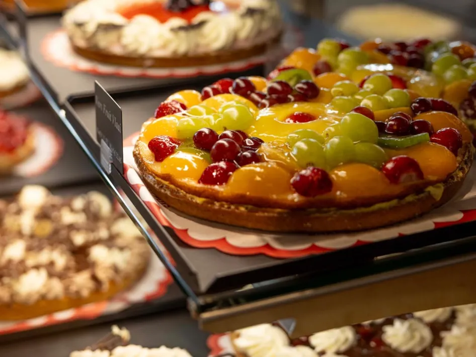 Obstvlaai mit Erdbeeren, Weintrauben und anderem frischem Obst in der Auslage von Bakkerij Puts in De Pannenfabriek in Echt.