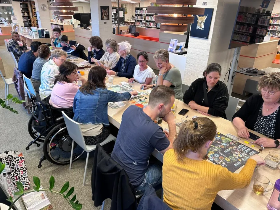 Spellenmiddag in Museum Peel en Maas met bezoekers van verschillende leeftijden die samen bordspellen spelen.