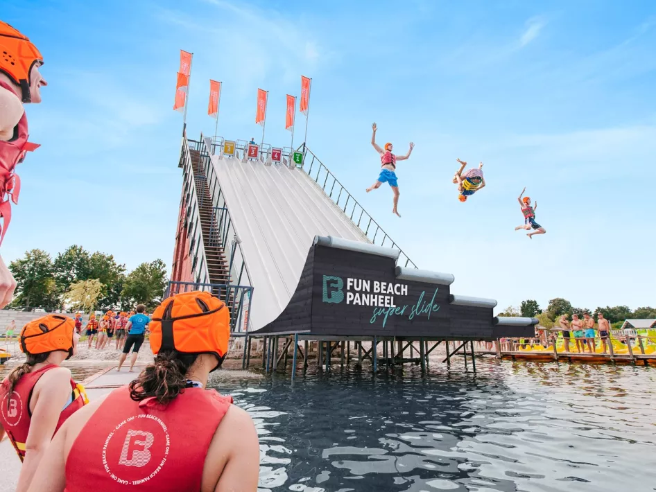 Visitors slide down the Super Slide while other people watch at Fun Beach in Panheel