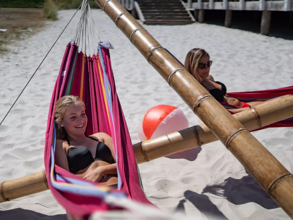 Young women relax in Fun Beach hammocks