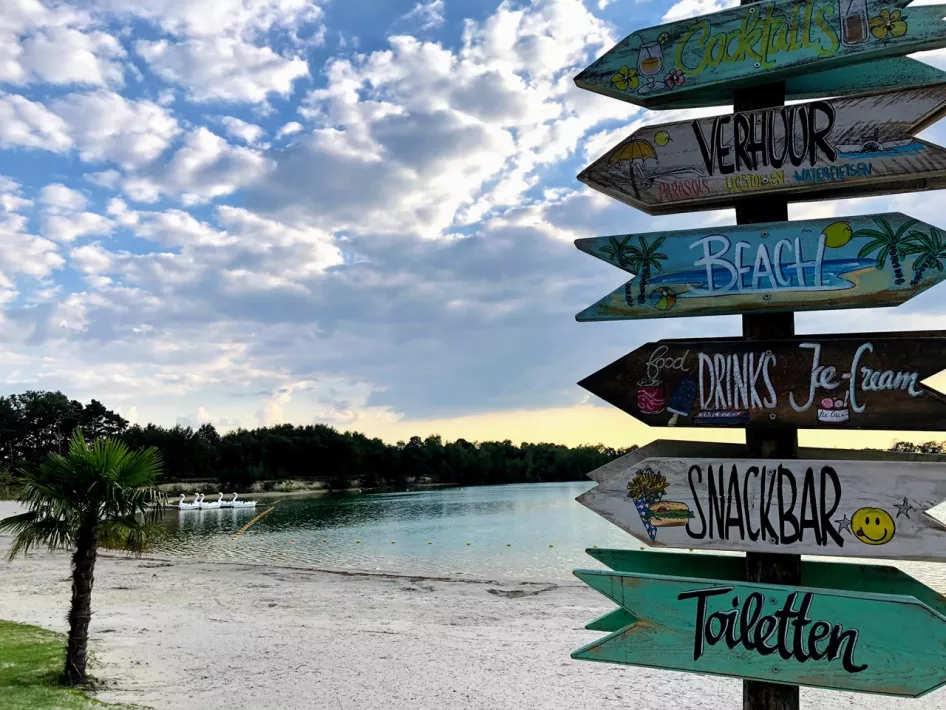 Signposts on het Blauwe Meertje beach showing facilities