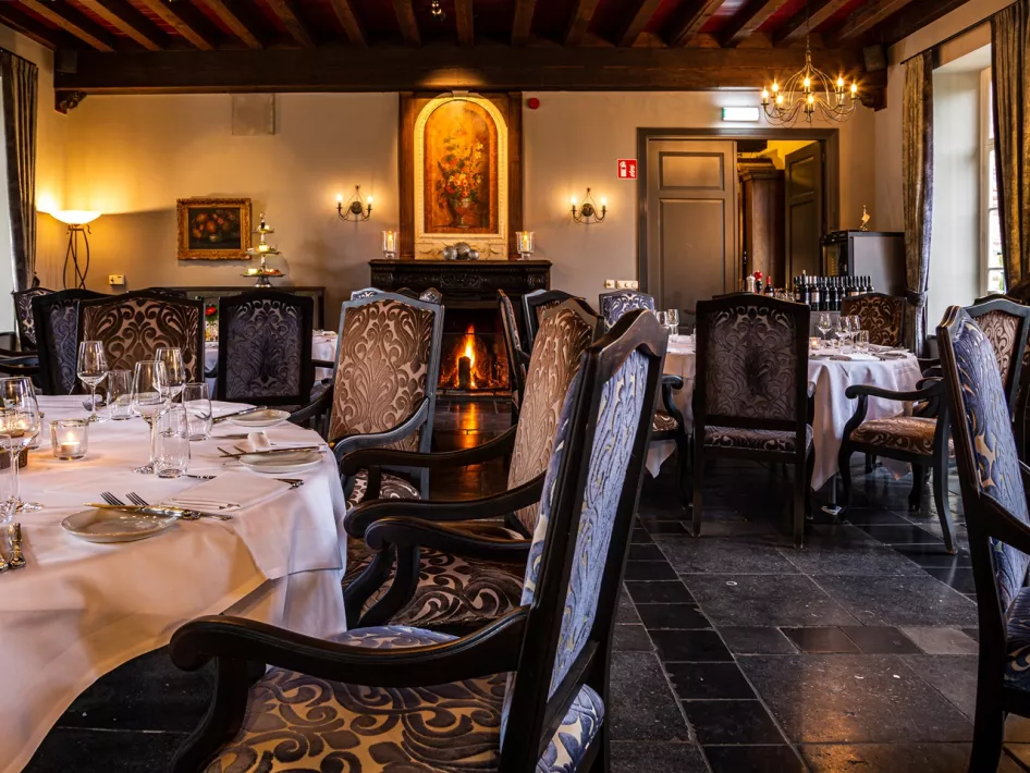 De sfeervolle eetzaal, met authentieke, houte tafels en stoelen