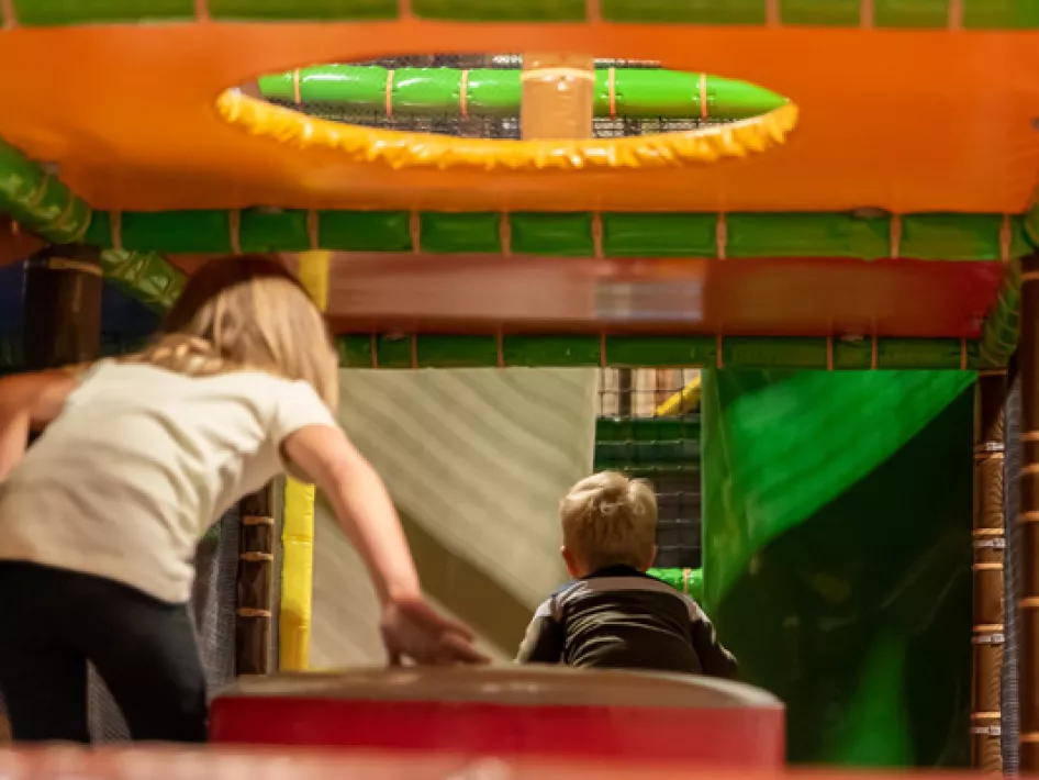 two children playing in an indoor playground