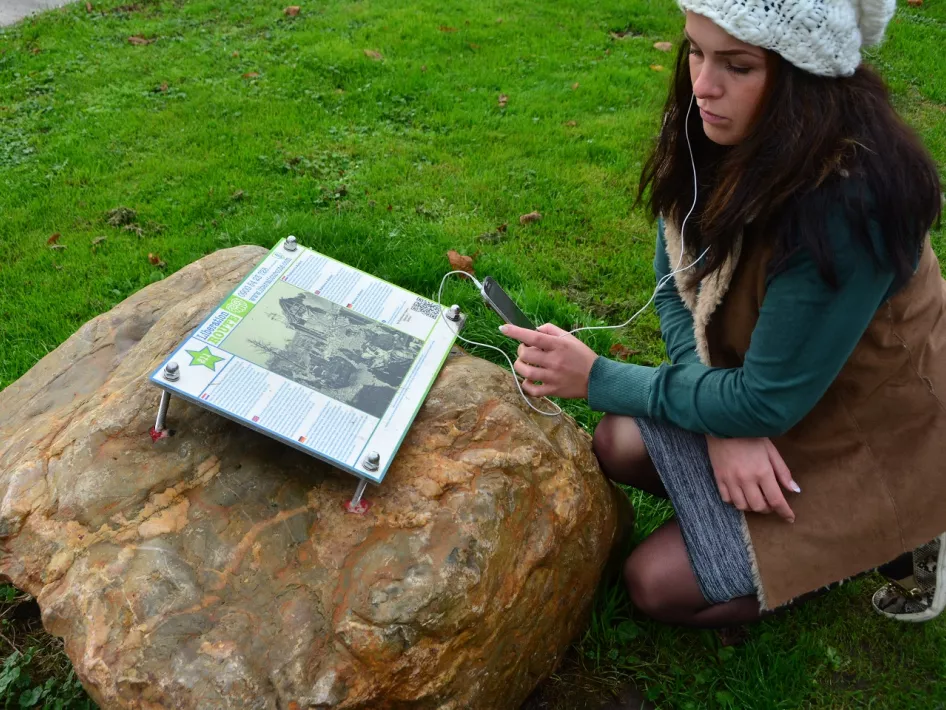 Woman listens to a Liberation Route story