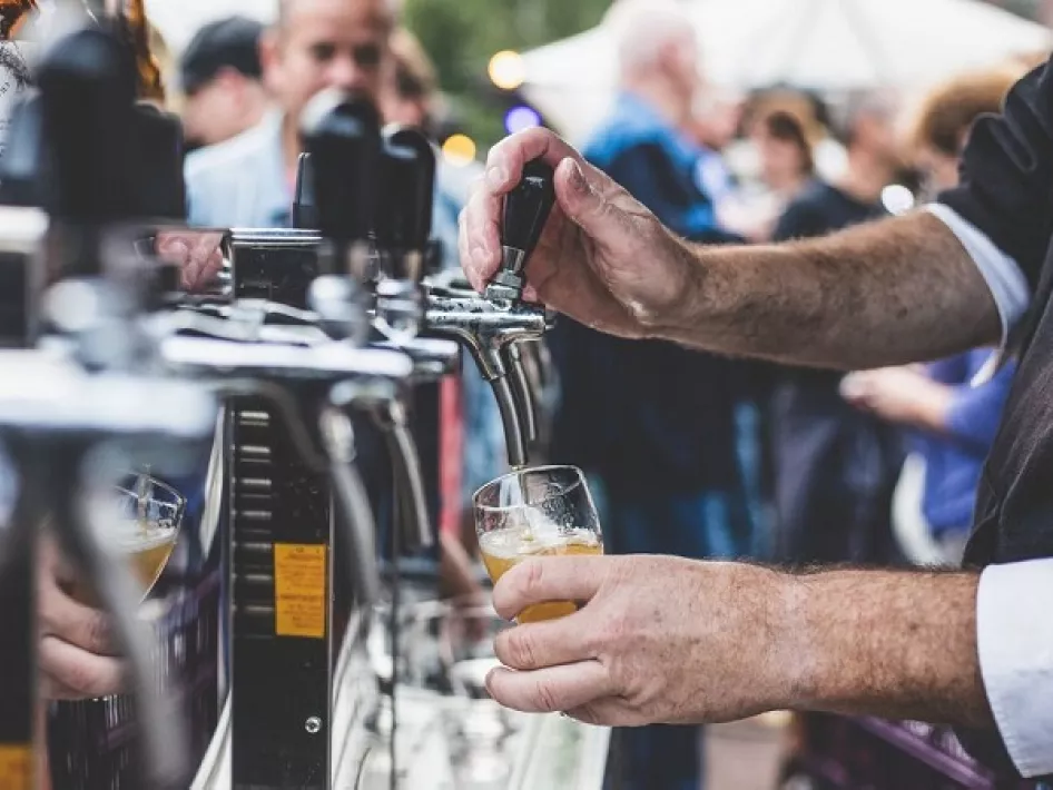 Bier wird gezapft beim Op Hop van Zegen Bierfestival in Roermond, mit Menschen im Hintergrund auf einem belebten Festivalgelände.
