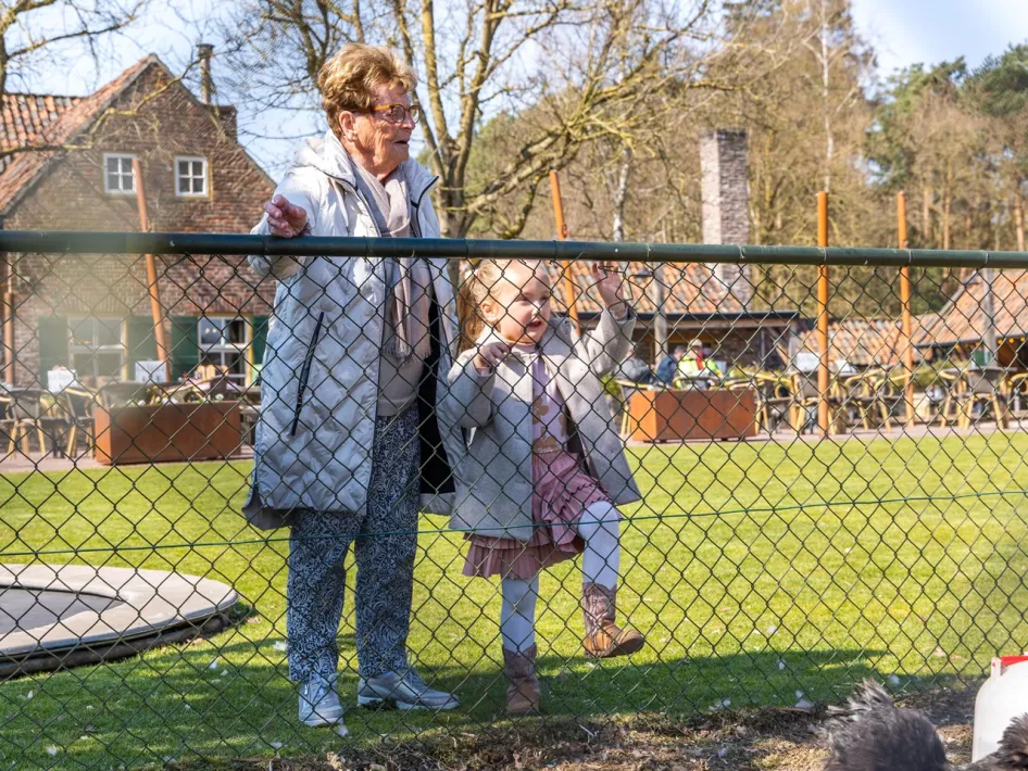 Grandmother and grandchild by the play area at Peerkesbosch in Nederweert
