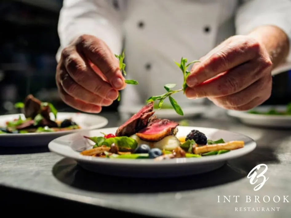 Gourmet dish with tender meat, vegetables, and fresh herbs.