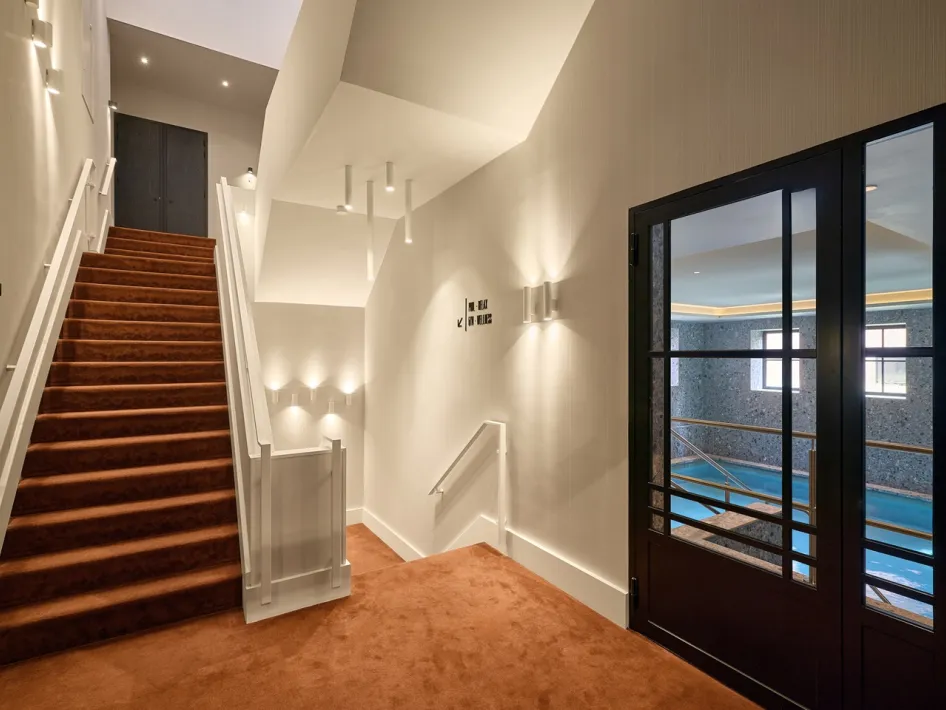 Staircase at TheaterHotel De Oranjerie overlooking the indoor swimming pool