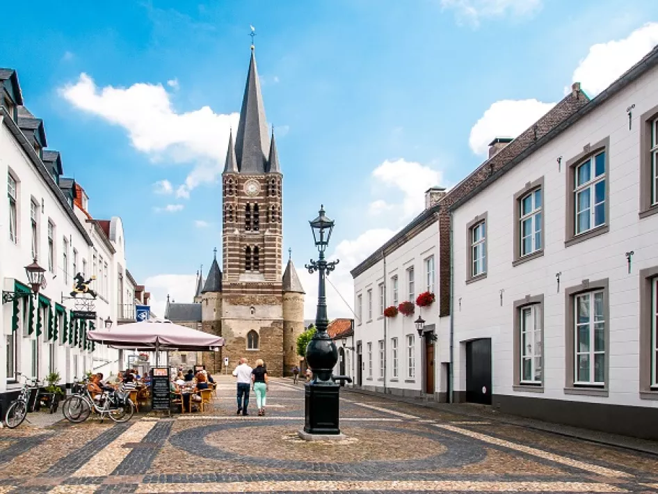 The abbey church rises above the white houses of Thorn