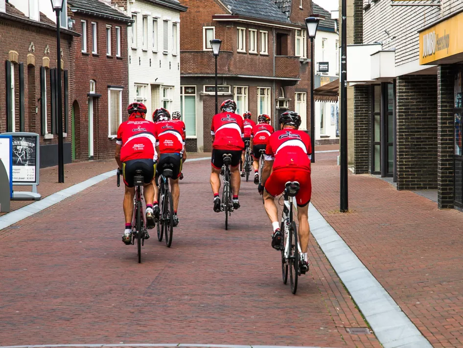A group of road cyclists rides through the streets on the Road cycling route – To Brabant and back.