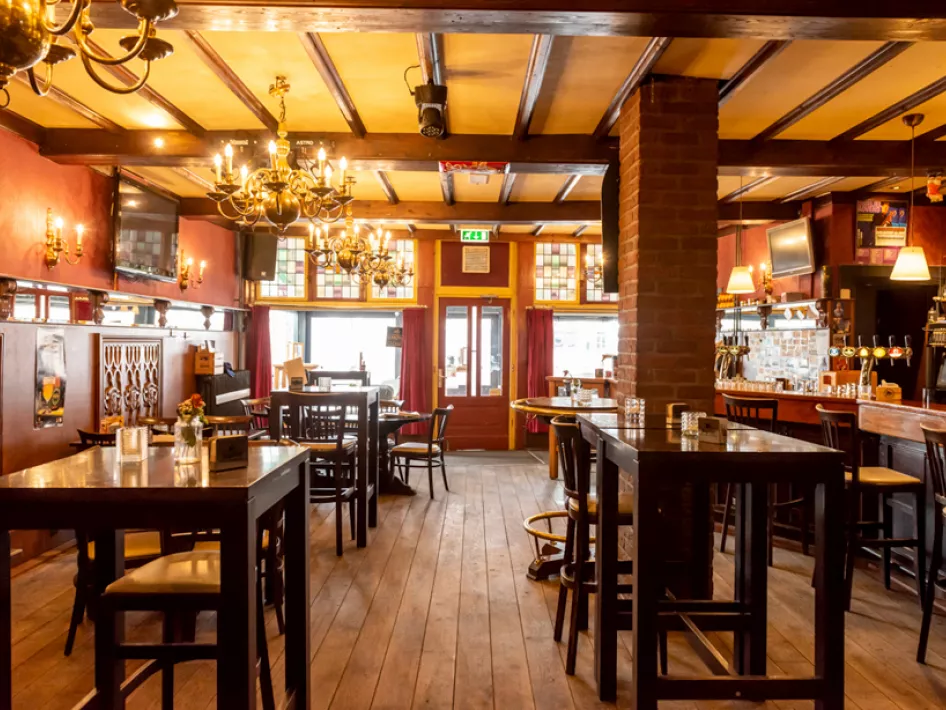 Café De Pauw set up inside with a variety of tables