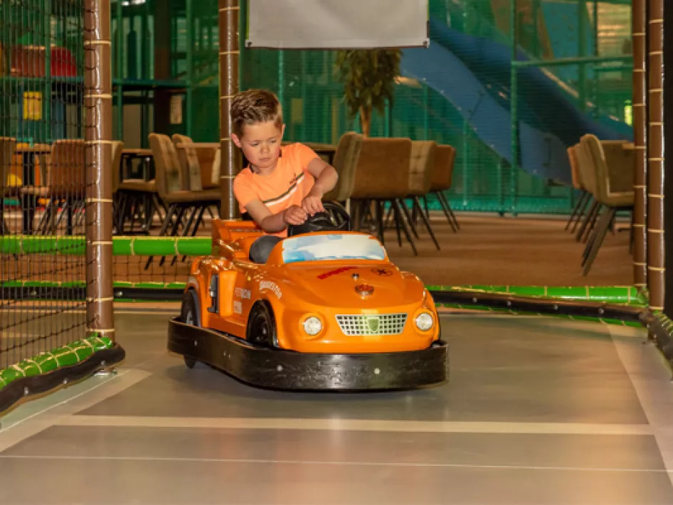 Boy is riding a bumpercar at Kidsplaza