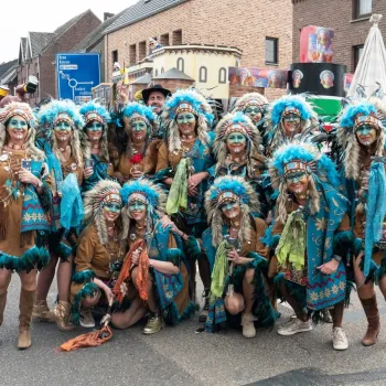 Feestelijk verklede groep deelnemers poseert tijdens de Halfvastenoptocht in Maaseik.